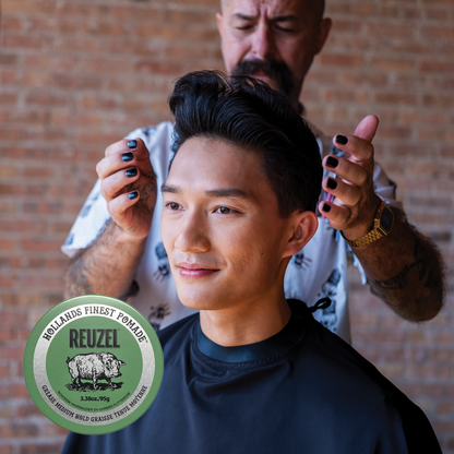 Green Reuzel Pomade grease jar showing branding and product label, ideal for styling hair with a classic, glossy finish.