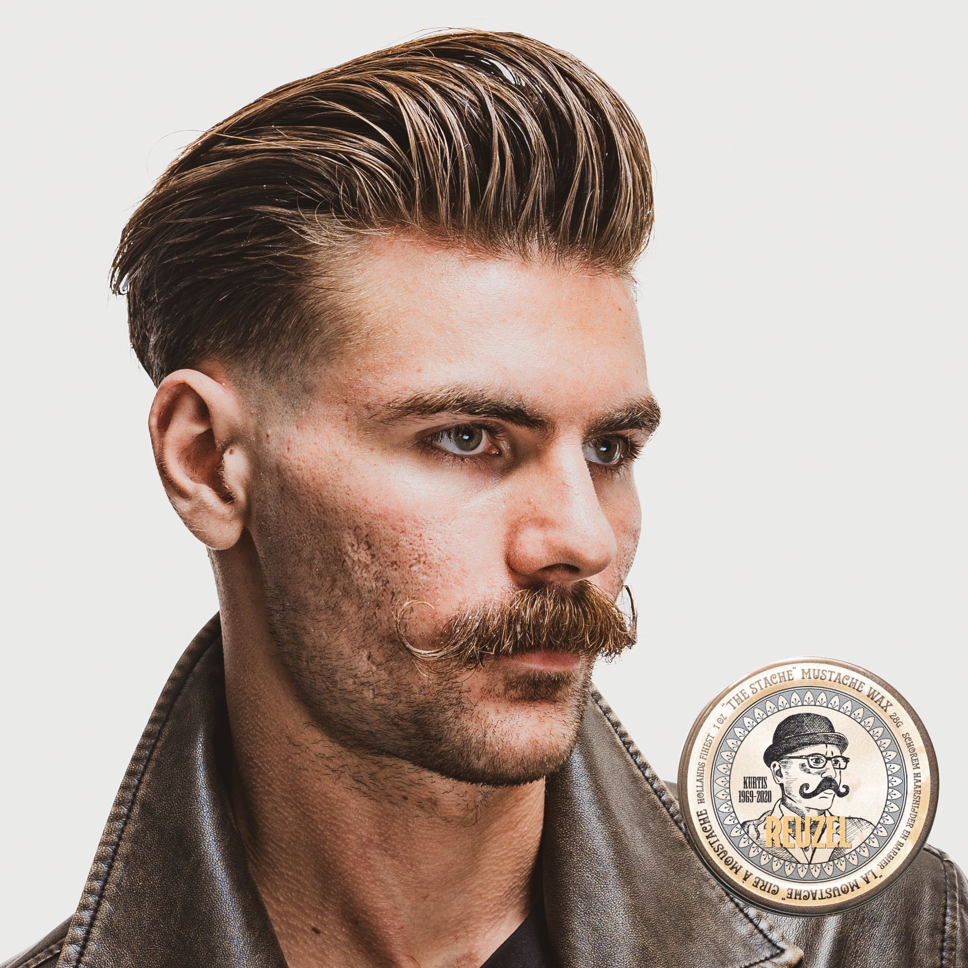 Reuzel The Stache Mustache Wax in a tin, designed for shaping and styling mustaches with natural finish and hold.