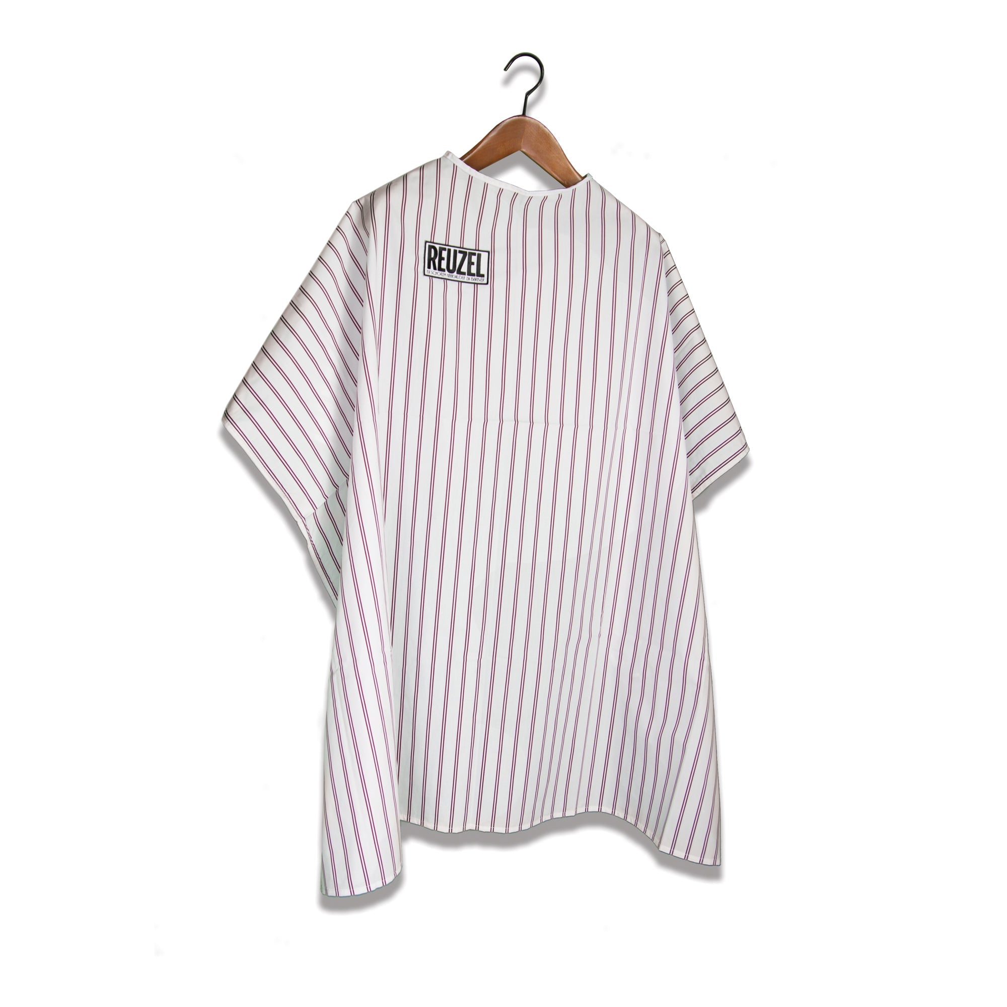 Reuzel Barber Super Cape worn by a barber, lightweight and adjustable for professional hair cutting and styling.