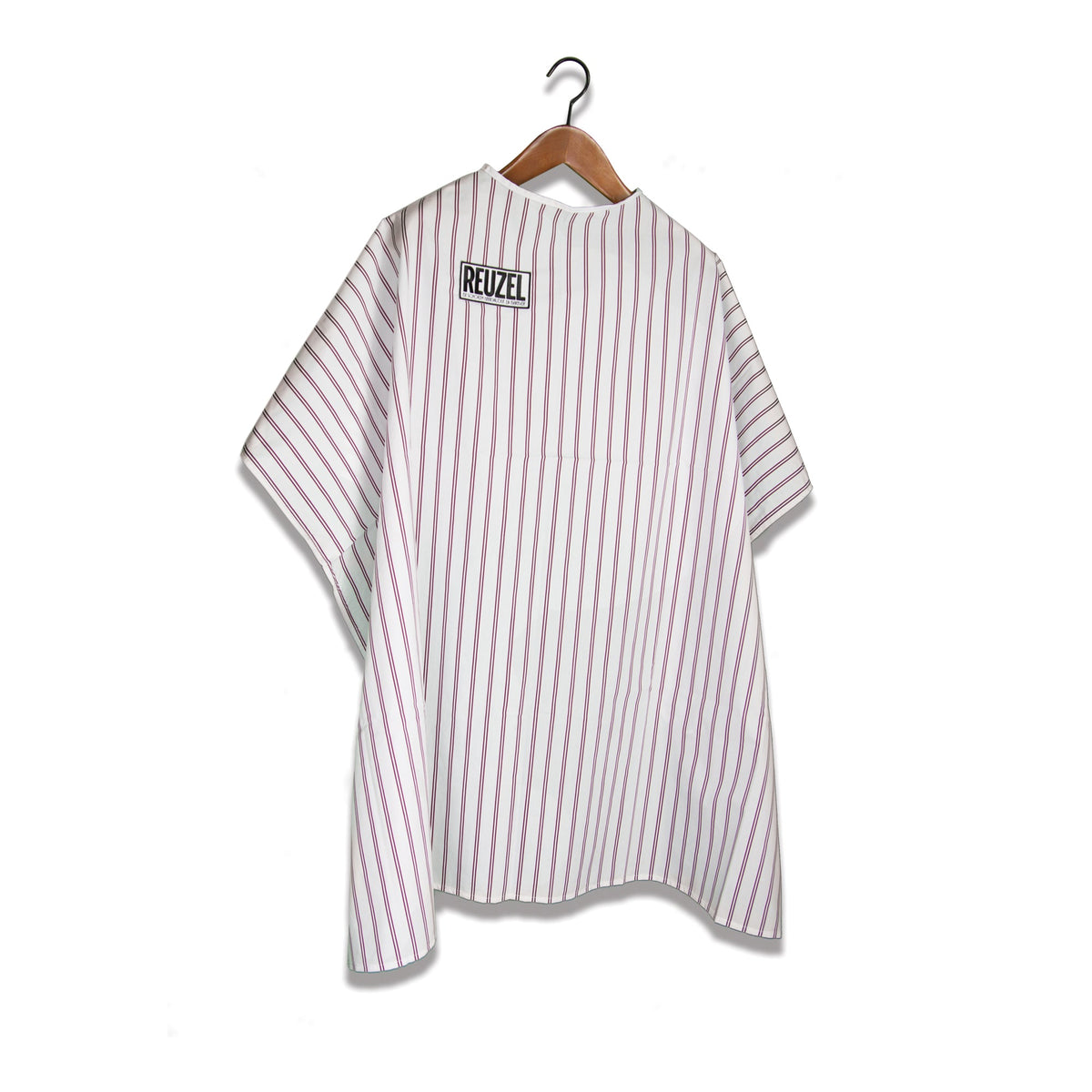 Reuzel Barber Super Cape worn by a barber, lightweight and adjustable for professional hair cutting and styling.